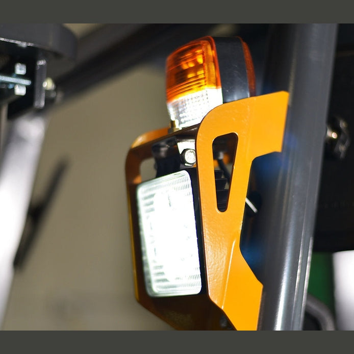 Front LED work light and amber turn signal mounted on the chassis of EKKO EK16A-138