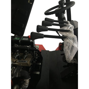 Close-up of a Kohler engine with a snow-covered landscape in the background