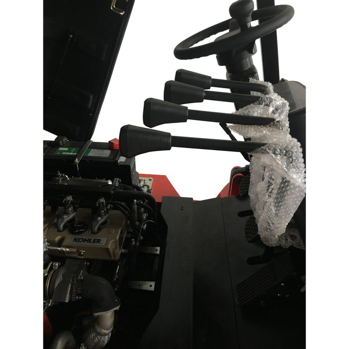 Close-up of a Kohler engine with a snow-covered landscape in the background